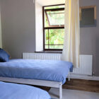 Bedroom with white bed with blue bed linen