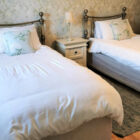 Bedroom with two single beds with metal headboards