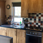 Pine kitchen units with fridge freezer, microwave and oven