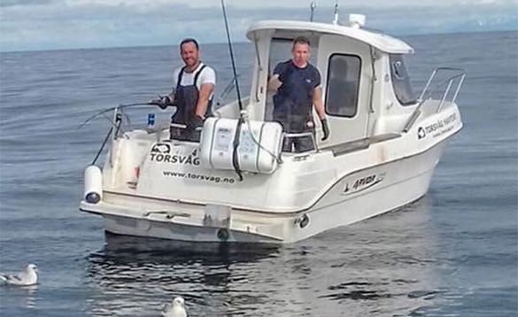 Two anglers fishing from a boat on calm Norwegian fjord