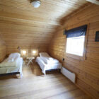 Pine clad bedroom with two single beds