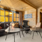 Log cabin living room with leather chairs and sofa