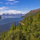 View across a fjord in Norway to mountains with snow on the tops