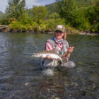 Lady angler holding a pink salmon caught in Alaska