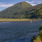 person fly fishing in a river in Alaska