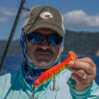 Angler holding a orange lure