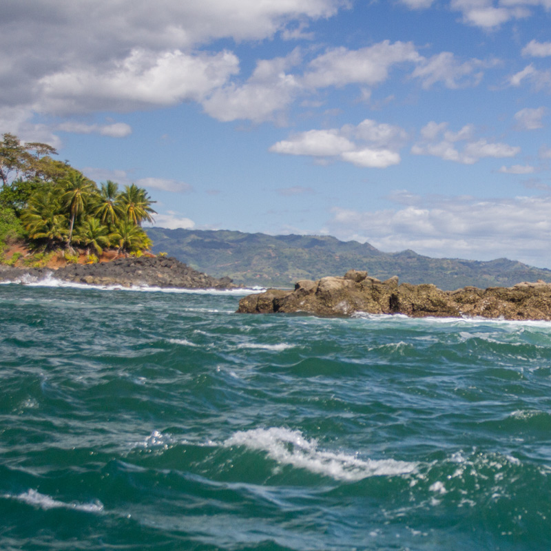 Waves breaking against a rocky outcrop in Panama