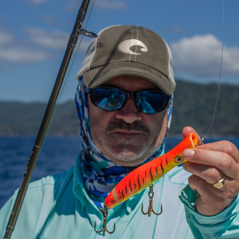 Angler holding a orange lure