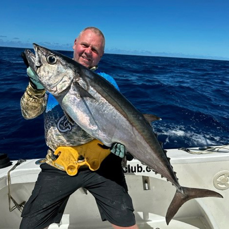 Angler holding a dogtooth tuna fish