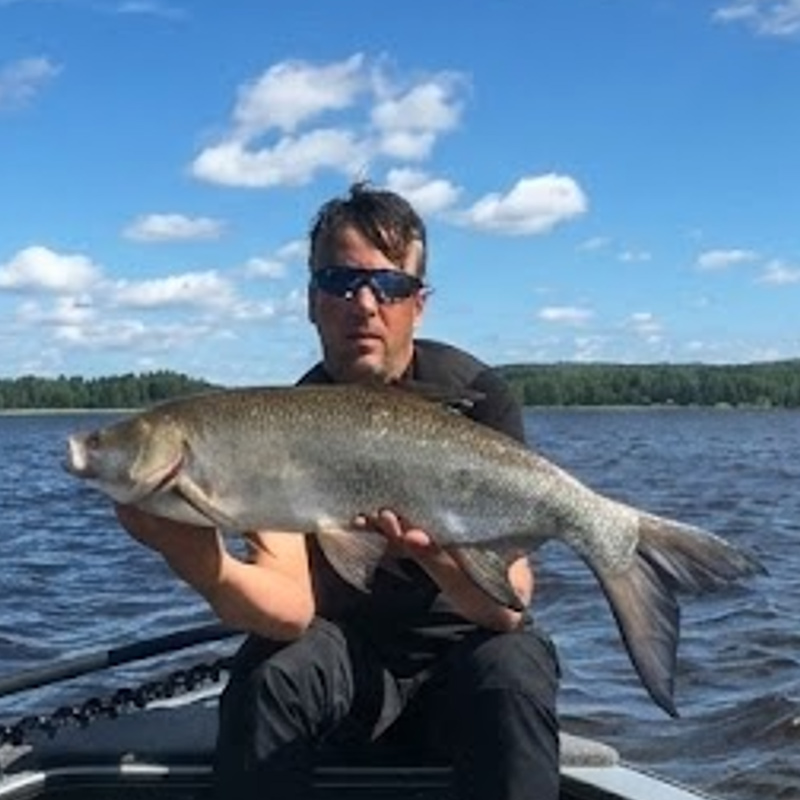 Anglers holding an asp caught in Sweden